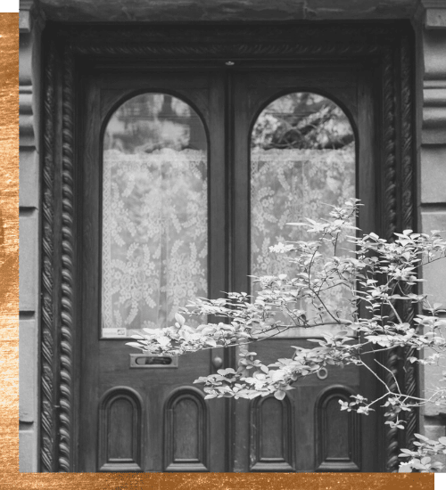 intuitive eating client testimonials - black and white image of a door with a flowery tree in front of it